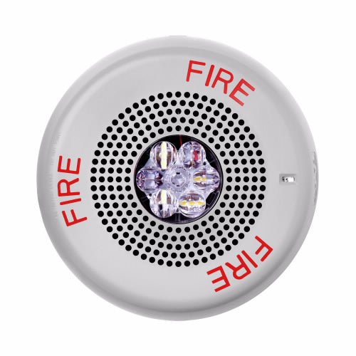 Eaton Wheelock Eluxa LED ceiling speaker-strobe in white, designed for voice alarm systems, mounted on ceiling with wiring visible.